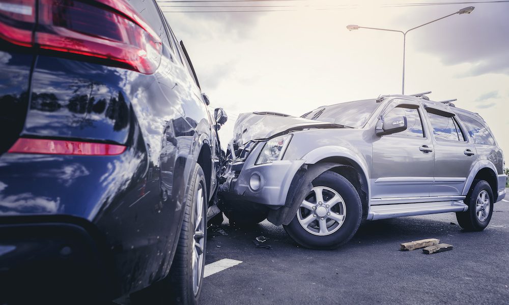 Car crash dangerous accident on the road. SUV car crashing beside another one on the road.